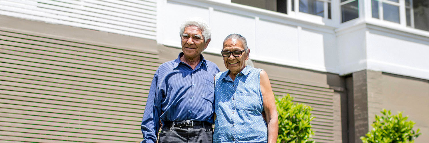 Aboriginal couple standing in their garden.