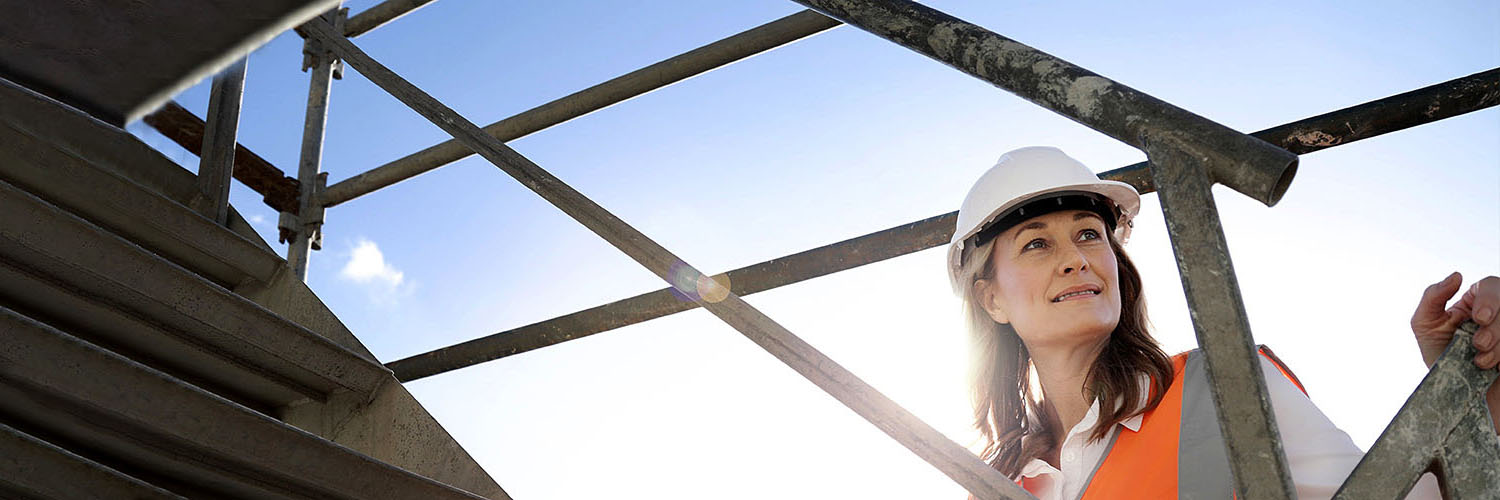 A female building certifier inspects scaffolding on a building site. Credit: NSW Department of Planning and Environment / Christopher Walters