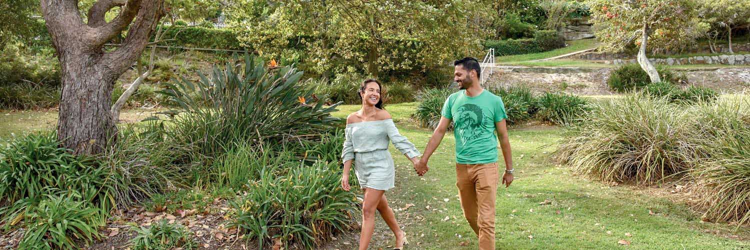 A young man and woman walk in Gardiner Park in Banksia, NSW. Credit: NSW Department of Planning and Environment / Adam Hollingworth