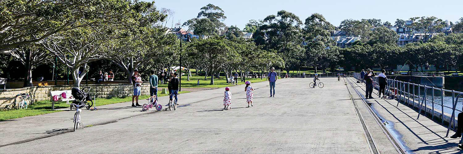 People walking and riding bikes at Blackwattle Bay Park.