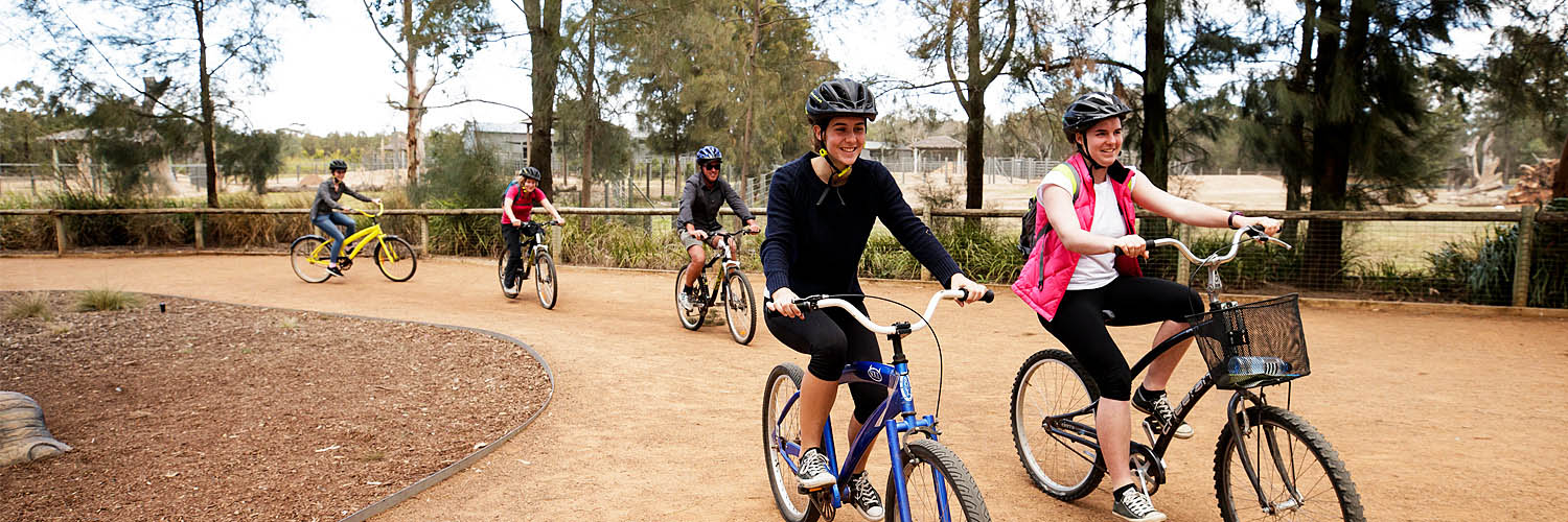 Small group enjoying a cycle around Taronga Western Plains Zoo, Dubbo. Credit: Destination NSW