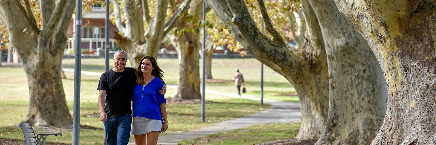 A man and woman walk through Arncliffe Park, Arncliffe, NSW. Credit: NSW Department of Planning and Environment / Adam Hollingworth