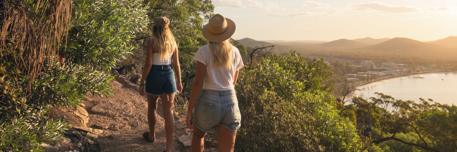 Friends enjoying a scenic walk along the Tomaree Head Summit Walk in Tomaree National Park, Port Stephens. Credit: Destination NSW