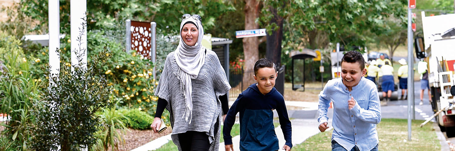 Family outside apartment block in Telopea, North West Sydney, NSW. Credit: NSW Department of Planning and Environment / Adam Hollingworth