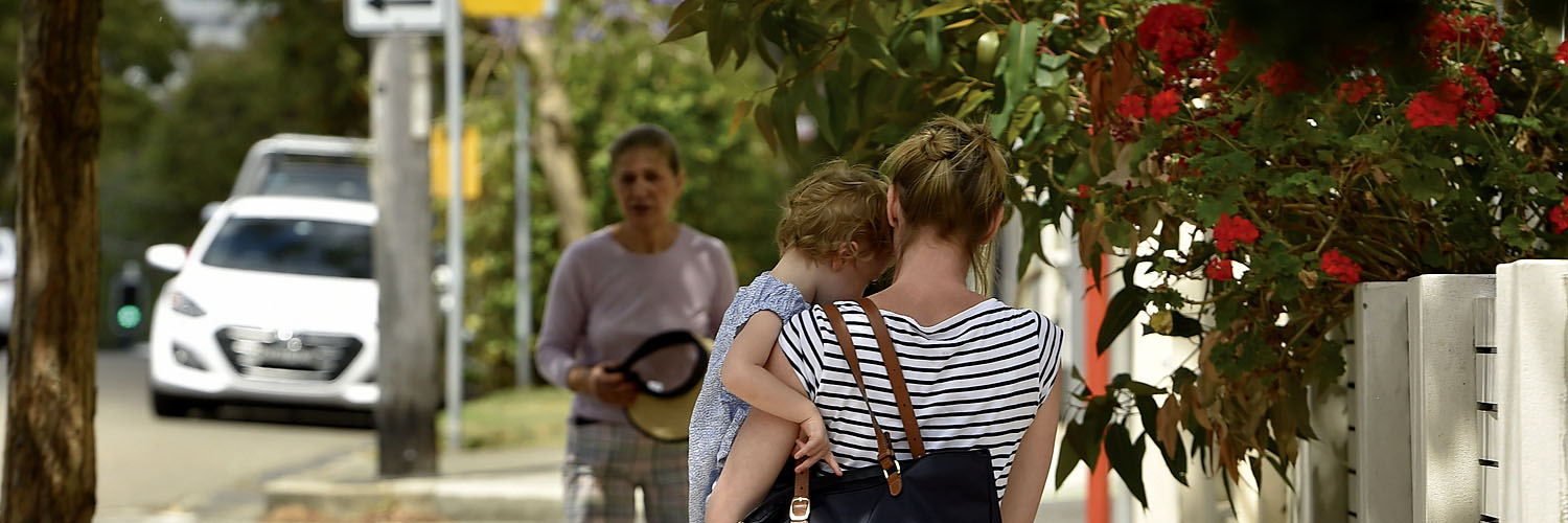 Mother with her child walking down the street in St Leonards, North Sydney, NSW. Credit: NSW Department of Planning and Environment / Adam Hollingworth