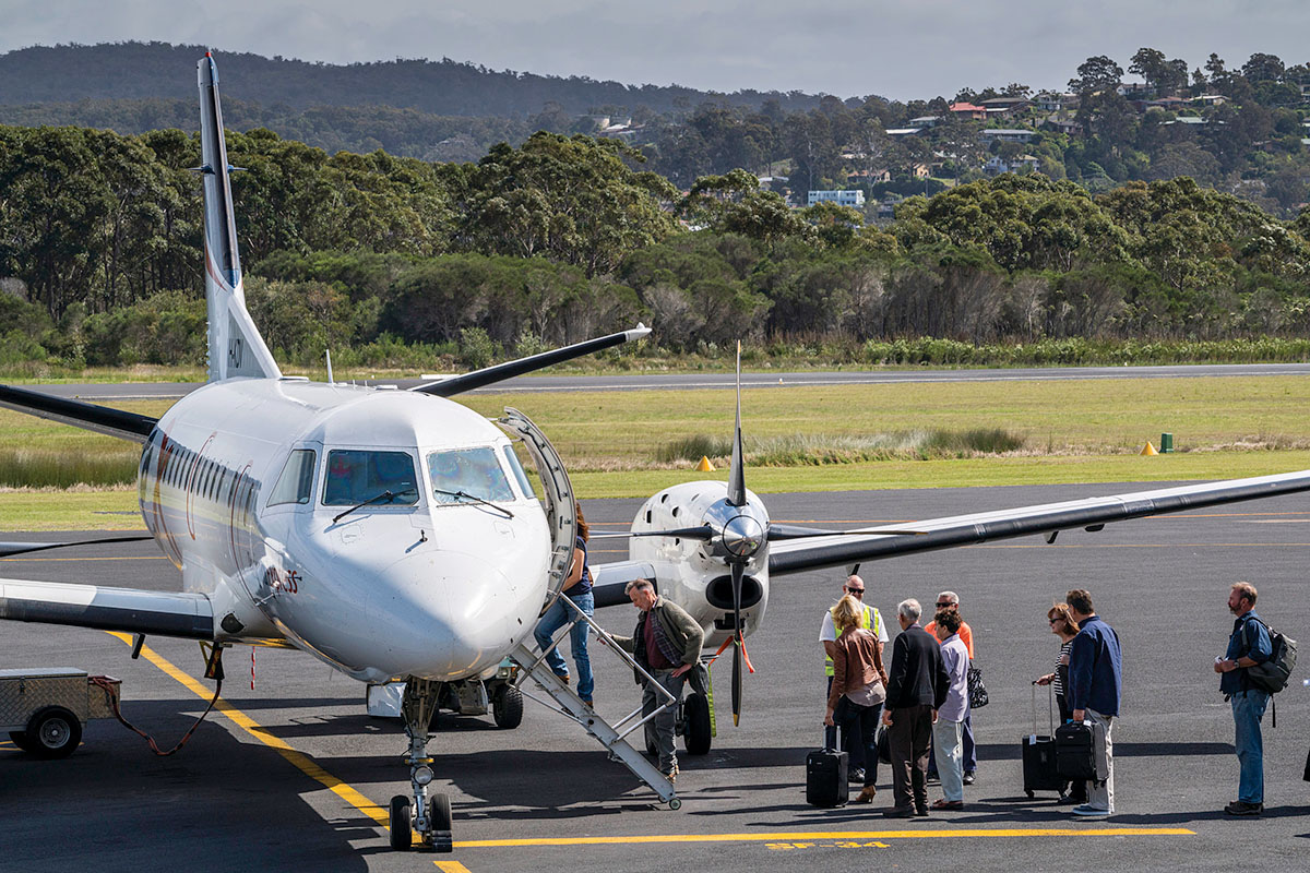 People boarding a plane at Merimbula Airport. Merimbula, NSW. Credit: NSW Department of Planning and Environment / Jaime Plaza Van Roon
