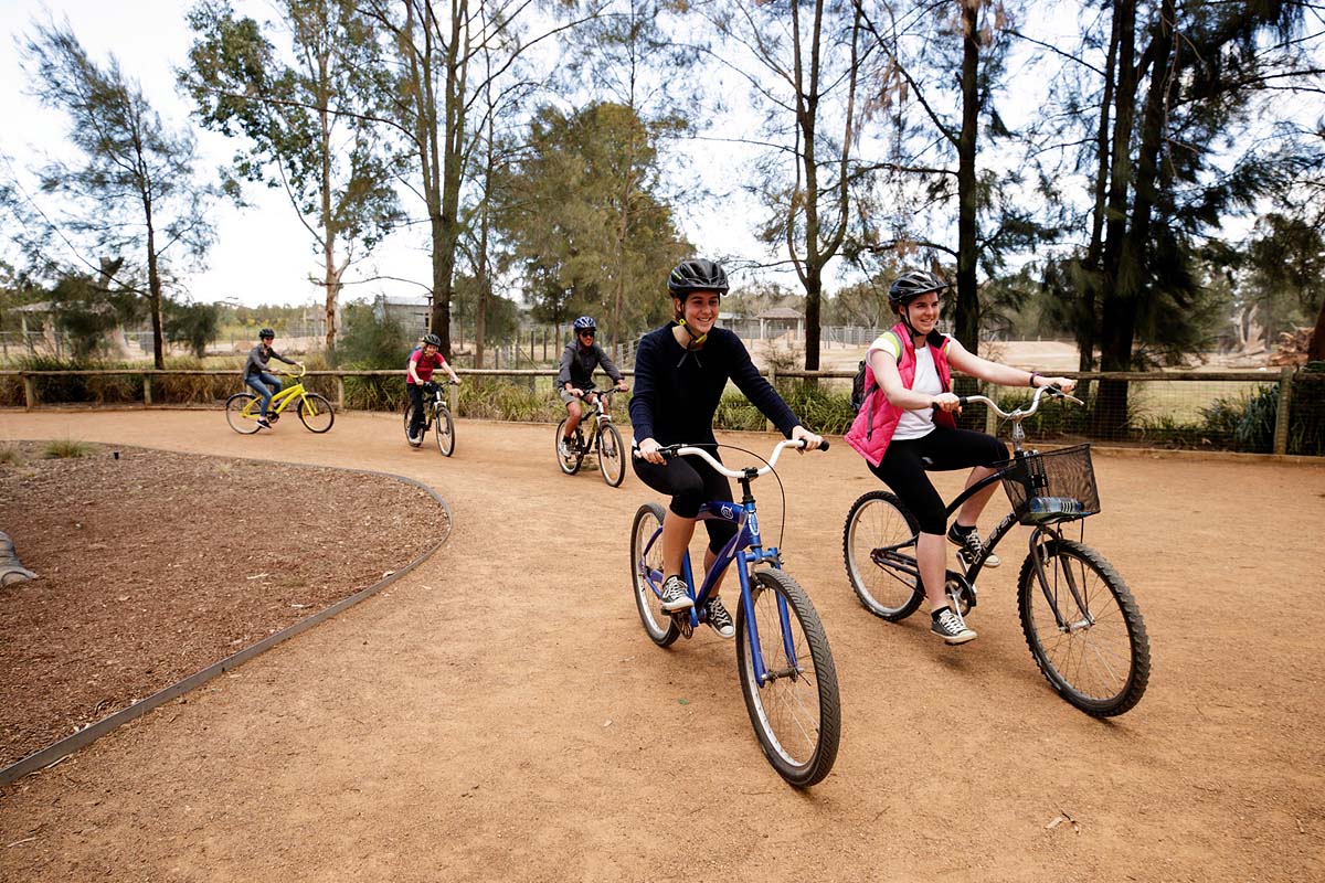 Small group enjoying a cycle around Taronga Western Plains Zoo, Dubbo. Credit: Destination NSW