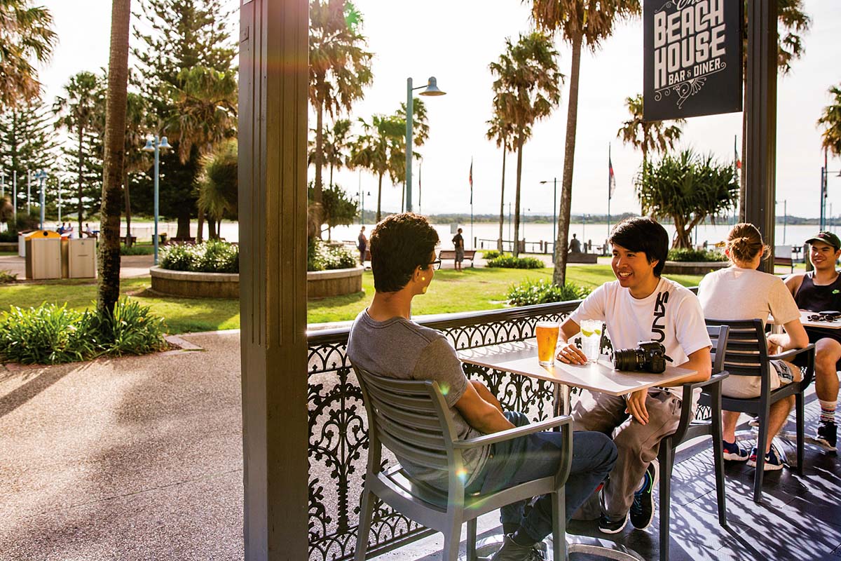 Friends enjoying afternoon drinks at The Beach House Restaurant and Bar, Port Macquarie. Credit: Destination NSW