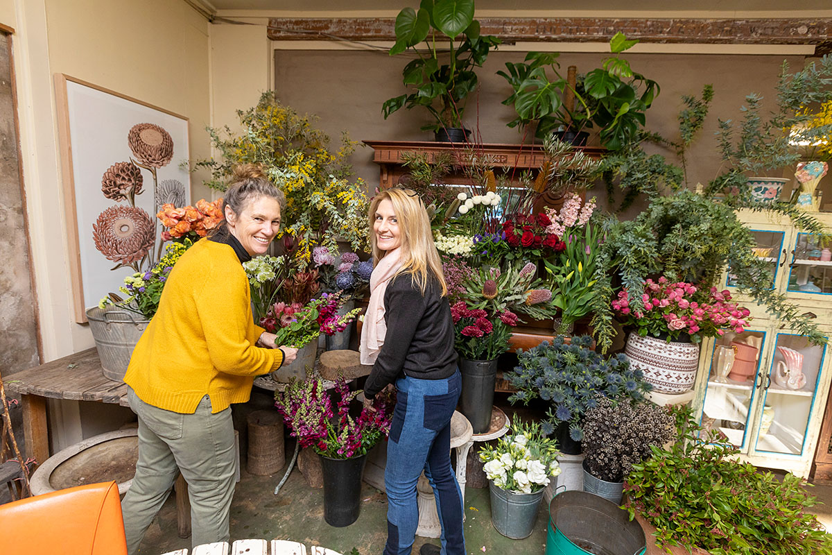 Two people looking at a florist's business.
