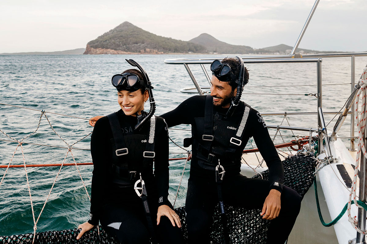 Couple enjoying a day out on the water with Dolphin Swim Australia, Port Stephens. Credit: Destination NSW