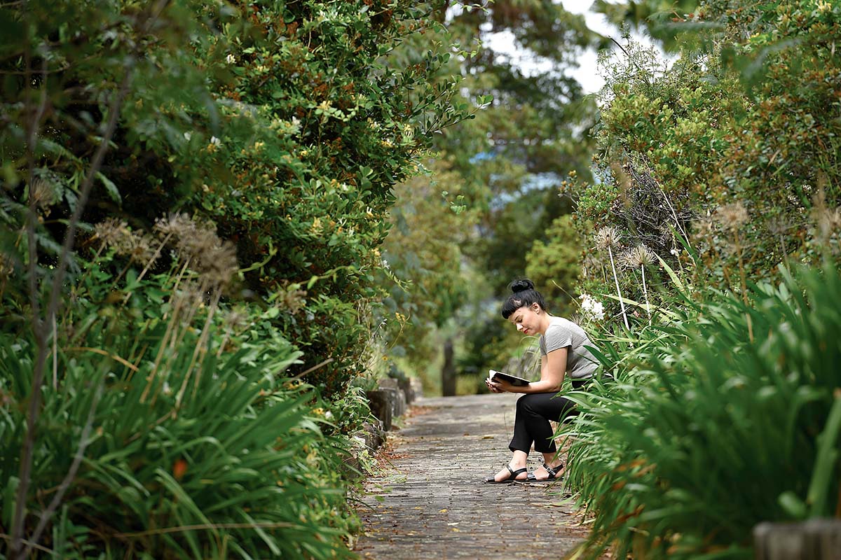 Woman reading on a bench in St Leonards, North Sydney, NSW. Credit: NSW Department of Planning and Environment / Adam Hollingworth