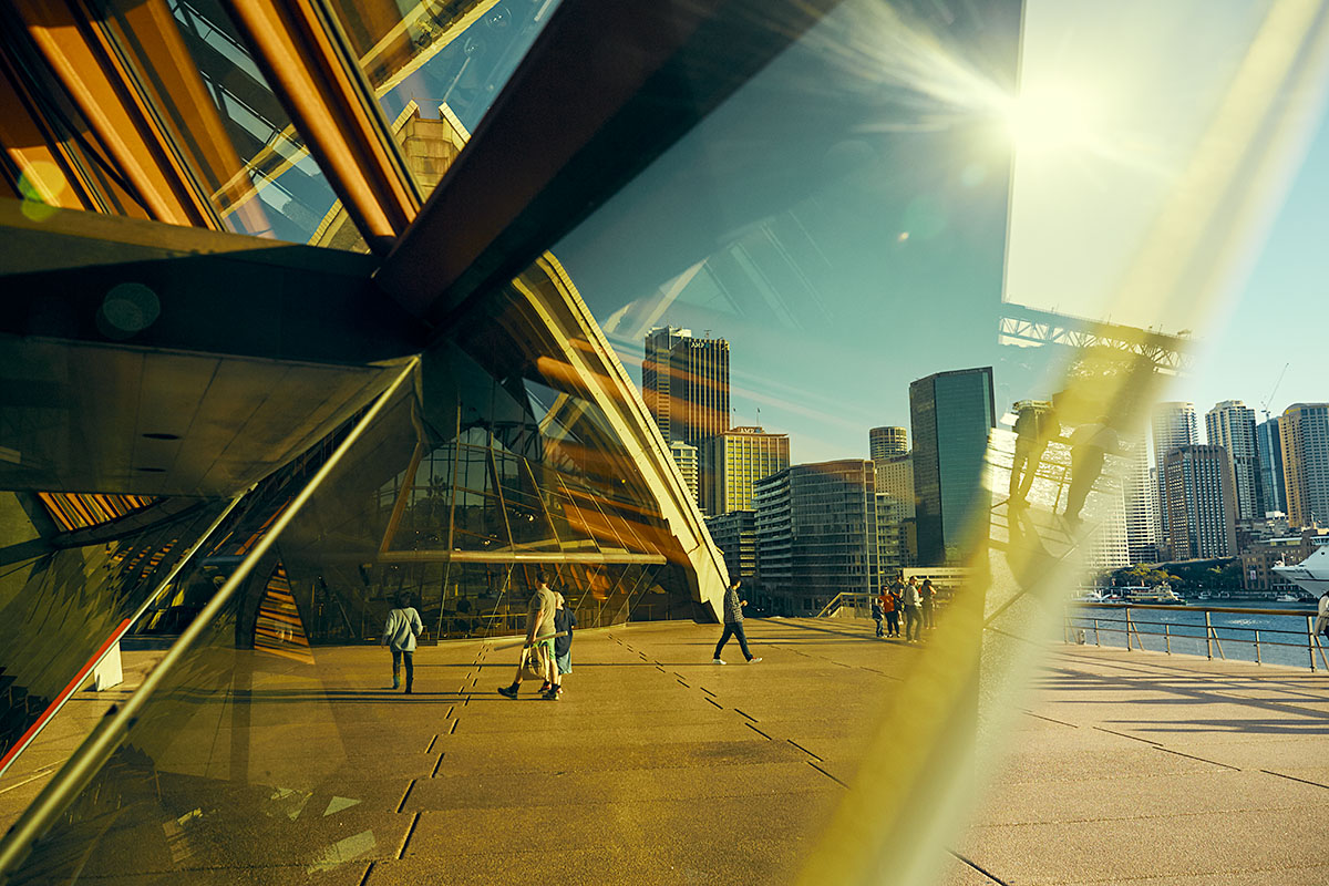 People walking in the afternoon sun outside the Sydney Opera House. Credit: Cory White / Government Architect NSW