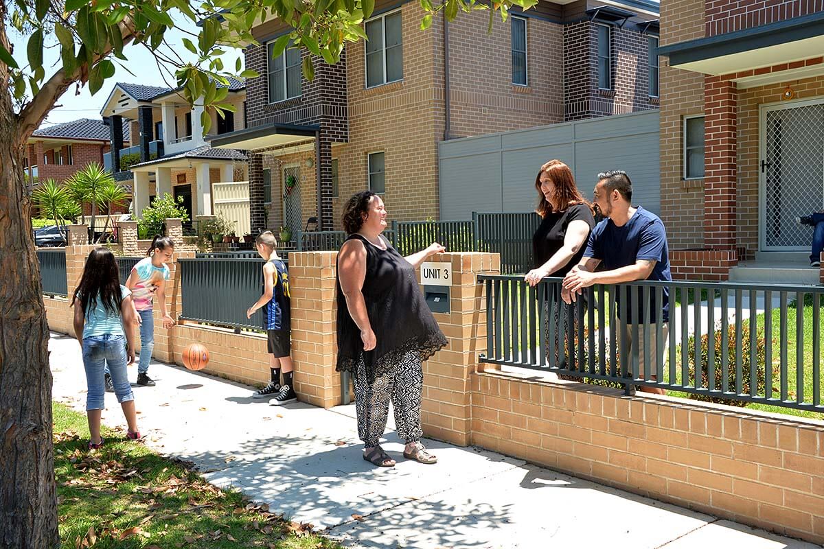 People socialising out the front of a social housing development. Credit: Fiora Sacco / Government Architect NSW