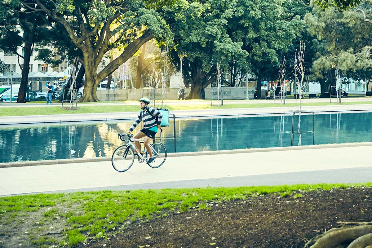 Person riding a bike near the ANZAC Memorial in Hyde Park, Sydney. Credit: Cory White / Government Architect NSW