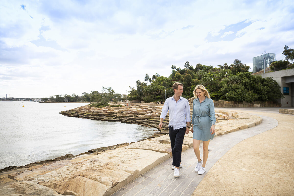Couple enjoying a walk around Nawi Cove in Barangaroo, Sydney. Image credit: Destination NSW