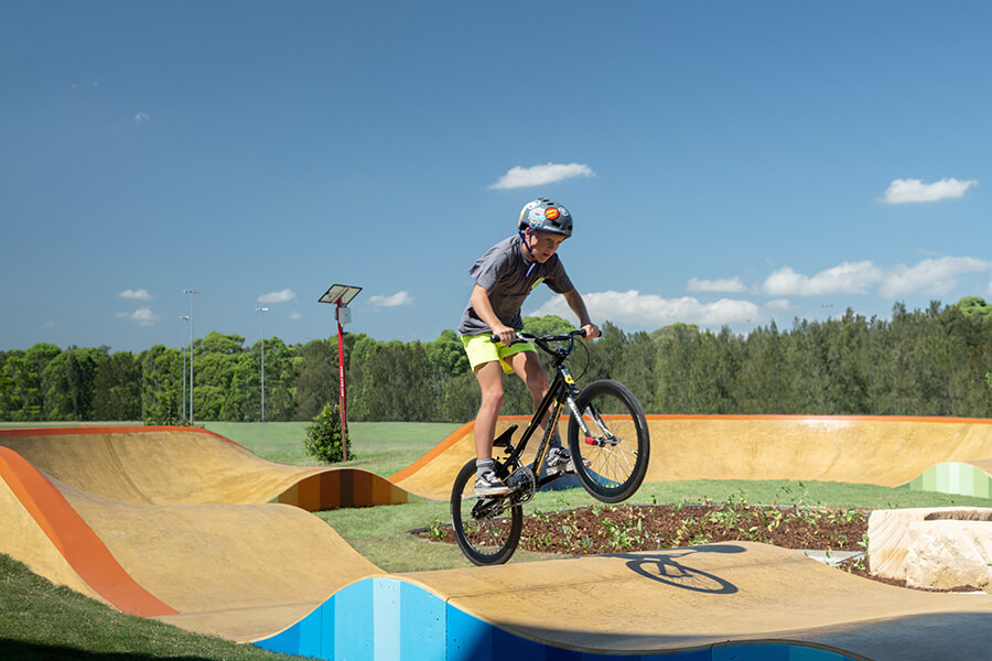 Person biking on a ramp on the new park in Beaumont Hills. Credit: NSW Department of Planning, Housing and Infrastructure 