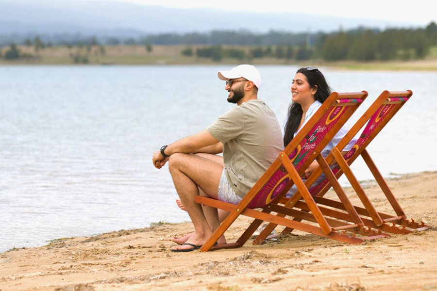 Two people relaxing at Penrith Beach in Western Sydney NSW.