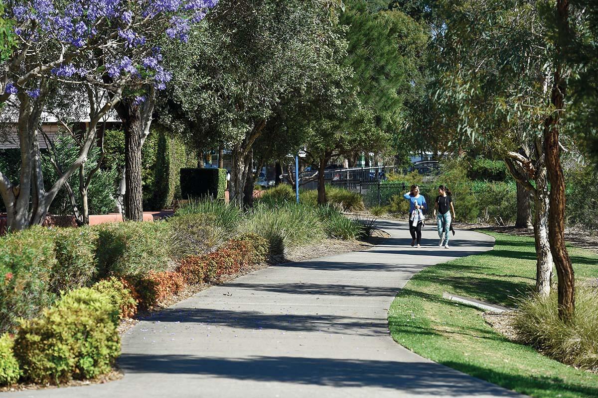 Friends walking in park area at Salt Pan Creek Reserve in Riverwood NSW. Credit: NSW Department of Planning and Environment / Adam Hollingworth