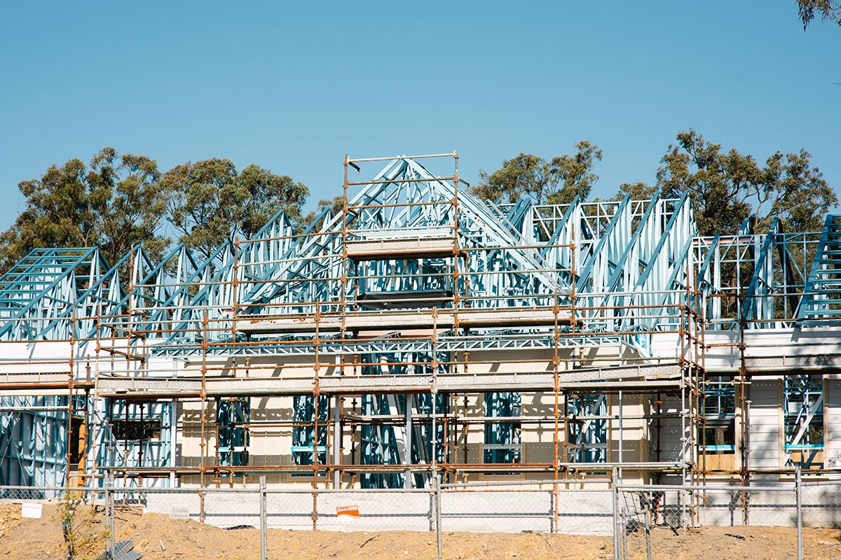 A house under construction, showcasing its steel frame structure.