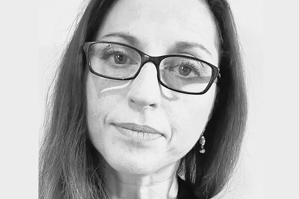 A black and white portrait of Gigi Lombardi.