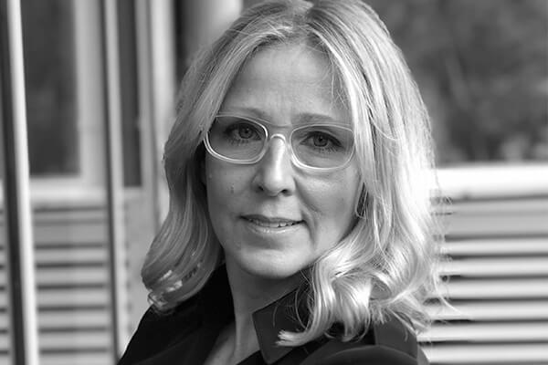 A black and white portrait photo of Jody Summers from the shoulders up.