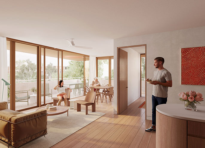 View from kitchen into living room with three adults talking and another adult on the balcony in the background stretching. 