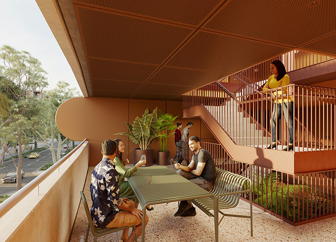 View of sheltered communal area with people interacting and plants in background.