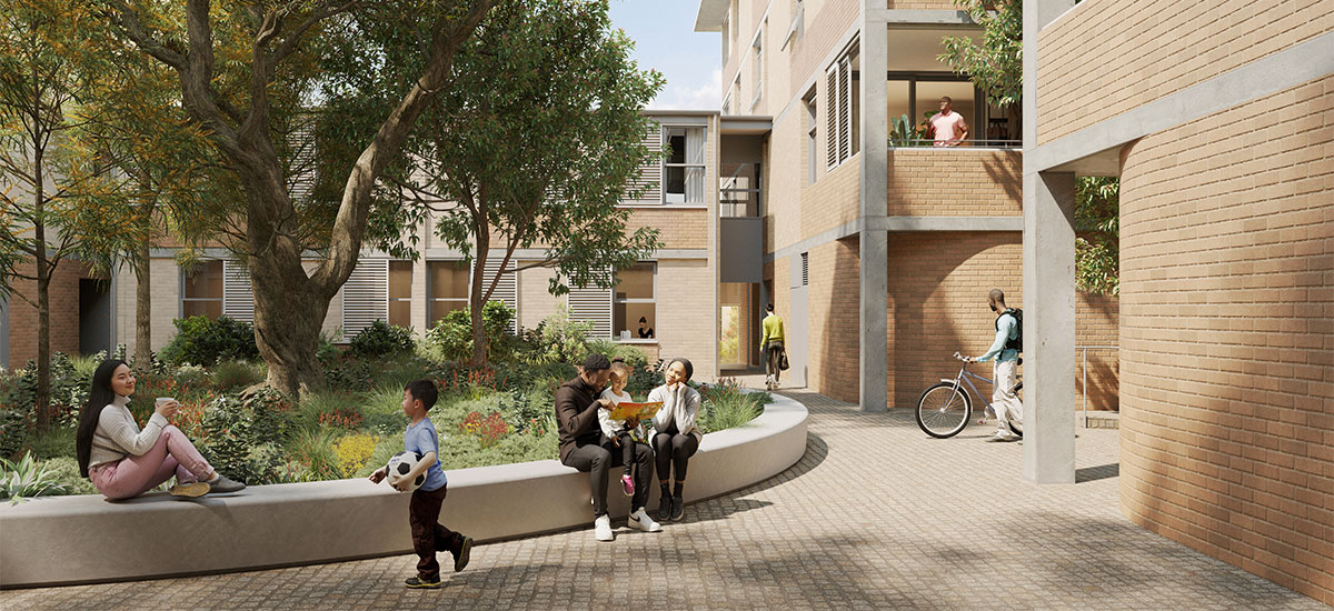 View of central communal outdoor area with 4 storey apartments on the left, two storey entrance in the background and families and planting in the foreground. 