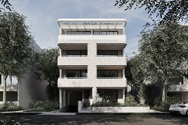 Street view of 4 storey apartment with blonde bricks. 