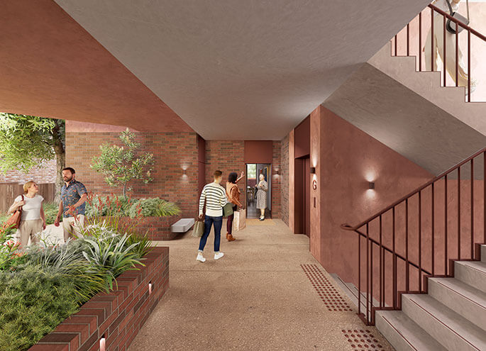 View of sheltered communal area with people interacting and plants in foreground.