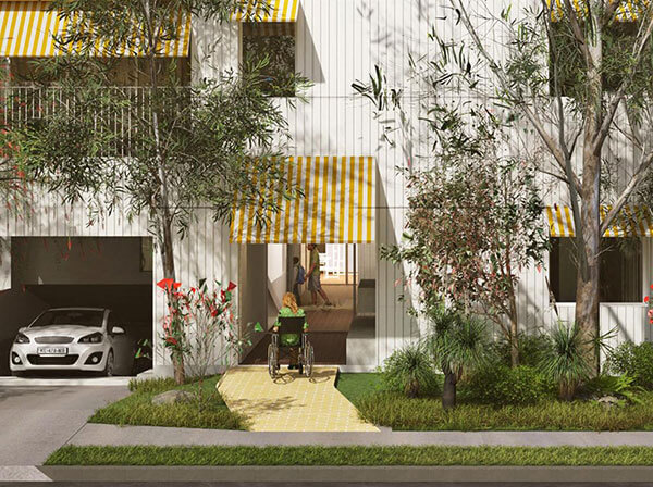Close up of entry into apartment building with yellow footpath and yellow awnings. 