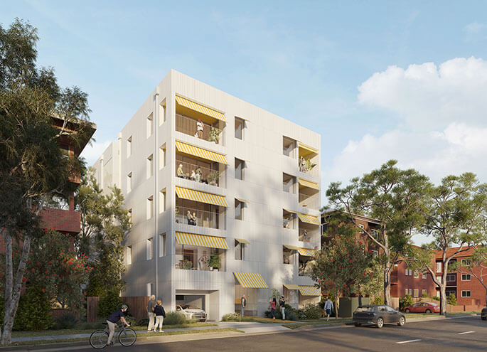 Angled street view of 5 storey apartment with two apartment blocks on left and right.