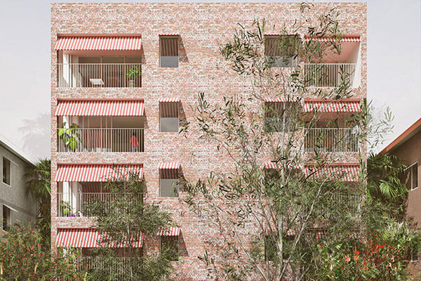 Street view of 5 storey apartment with red brick and red awnings.