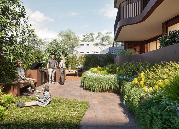 View of people socialising in the garden behind an apartment building with barbecue.