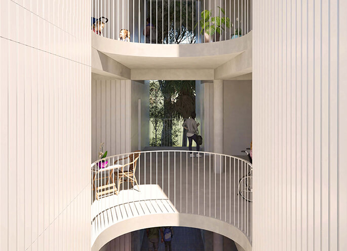 Curved balcony with metal railing and view to a garden.